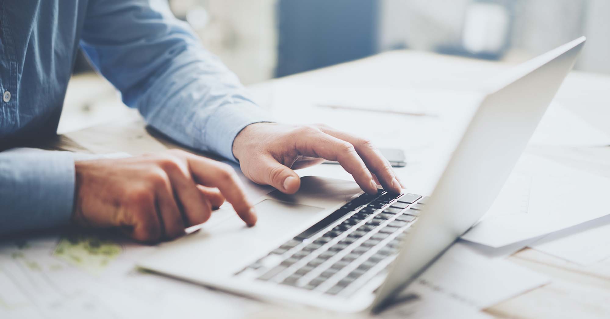 -Businessman-using-laptop-for-architectural-project.-Generic-design-laptop-on-the-table
